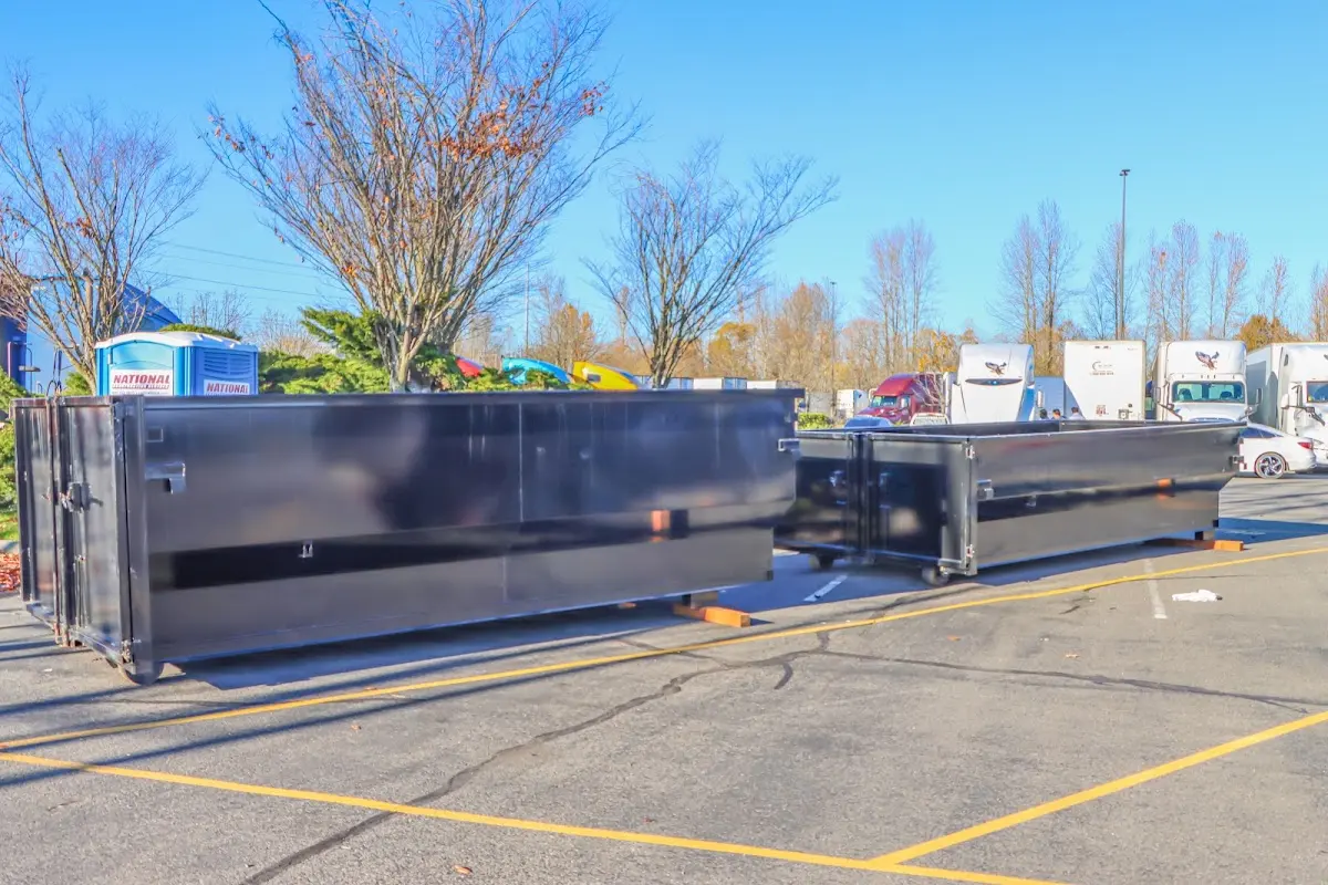 Professional dumpster rental service with roll-off container on residential driveway in Kenton